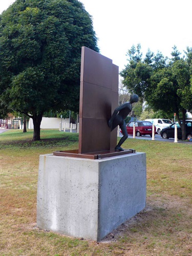 Guy Buseyne, The Wall. Trumper Park, Paddington. The former graphic artist Guy Buseyne studied the craft of furniture making before exploring the plastic and ceramic arts. The Wall is an elegant and expressive figurative work made of Corten steel.