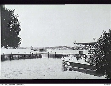 Rose Bay, NSW. Crash Launch RAAF 08-97 at its mooring. In the background is VH-ABG, a Short Empire Flying Boat S.23 (also known as a Short Empire).