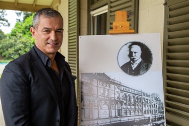 Paul Zahra CEO, Australian Retailers Association, with a portrait of Frederic Lassetter and an image of ‘Lassetters’ store in George Street
