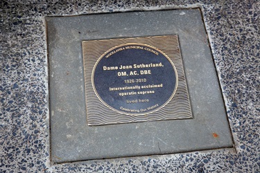 Bronze plaque which is located on the footpath outside her former home