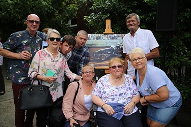 Relatives of Jeffrey Freeman with his portrait