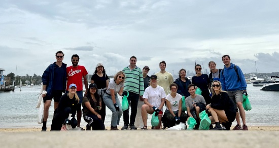 group with bags of litter on beach