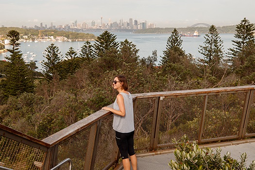 Woman standing in Gap Park looking at city and harbour skyline