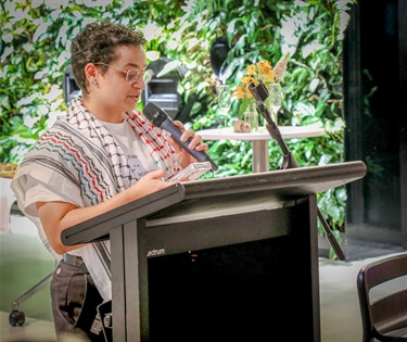 Adrian Mouhajer accepting the Readers' Choice award on behalf of Sara M. Saleh.