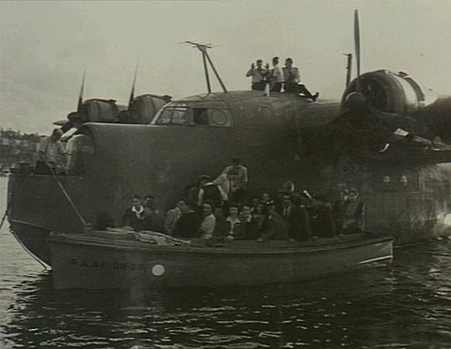 Civilians leaving the Short Sunderland aircraft and boarding a RAAF launch