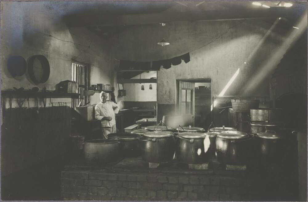 Photograph of a cook in a large kitchen