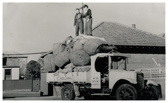 Volunteers with the Woollahra branch of the National Emergency Services distribute sand bags