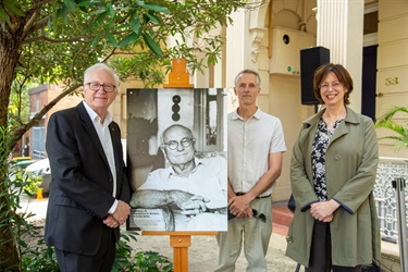 Professor Stephen Garton, Julius Pucci (cousin of Julia Horne), and Julia Horne with a photograph of Donald Horne at his Woollahra home.