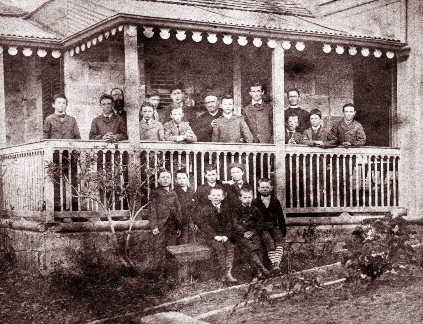 Mark Sheldon (front row, right) aged 8 on the verandah of Riverview cottage in 1880 with Fr Dalton SJ, staff and students. Source: Jubilee Book 1880-1930 pages 8-9, St Ignatius College Riverview. 