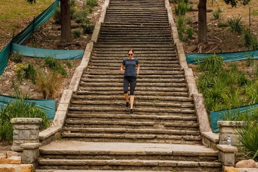 Woman running on Cooper Park stairs