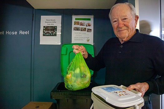 Dr David Wilson putting compost in green bin