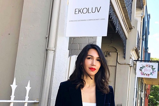 Woman in front of shop with EKOLUV sign in background