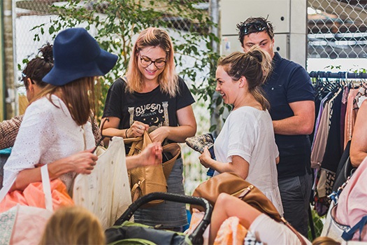 Women at a market buying clothes