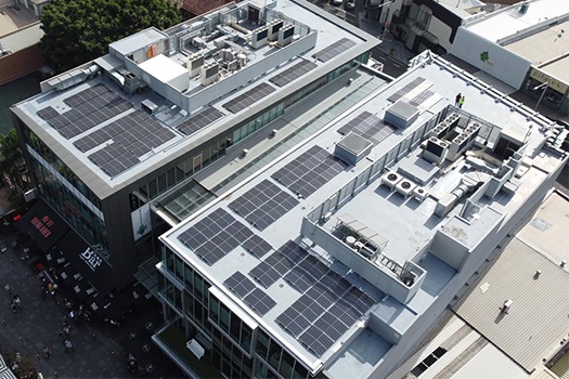 Drone image of the solar panels on the roof with Kiaora Lane in the foreground