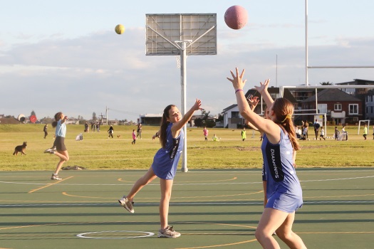Girls playing netball on the new multi-purpose courts
