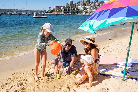 Two female children and mum and dad playing on Redleaf beach