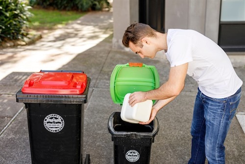 male placing scraps into small bin